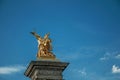 Marble column with golden statue adorning the Alexandre III bridge over the Seine River in Paris. Royalty Free Stock Photo